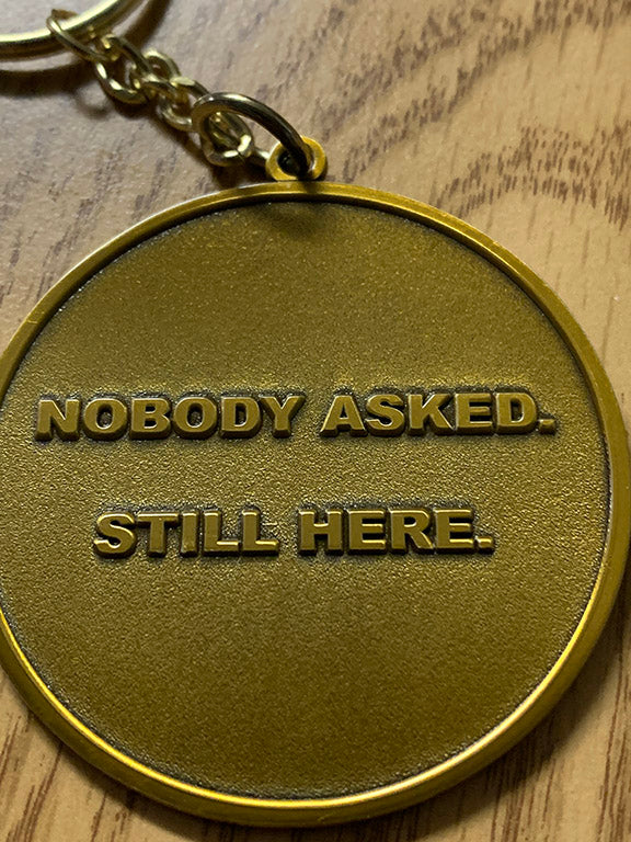 Nobody Asked. Still Here. Collector Keychain